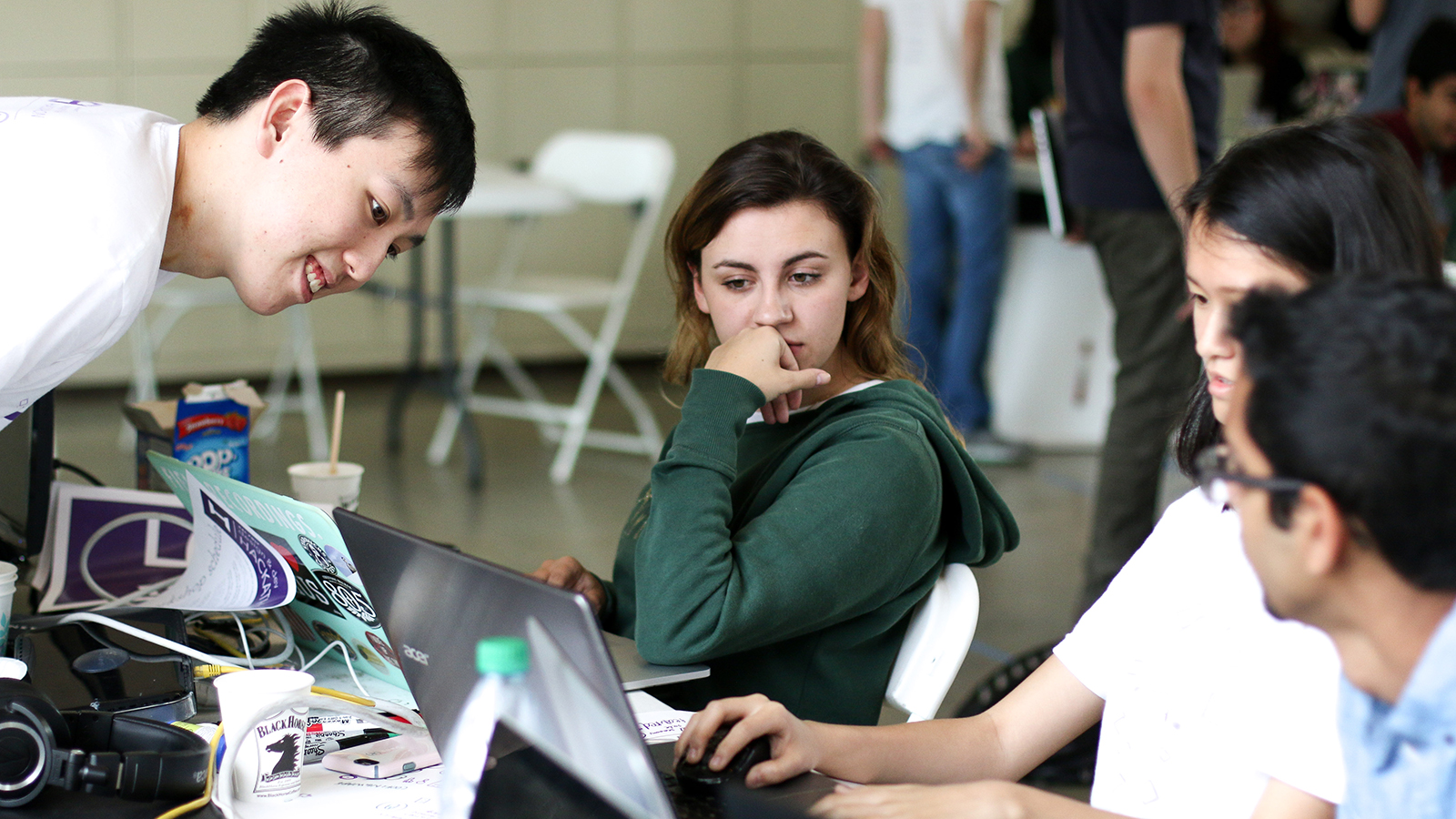 Group of students work together at a hackathon event.