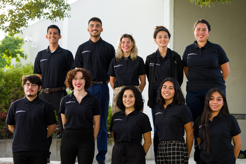 Ten Society of Hispanic Professional Engineers board members stand in black polo shirts 