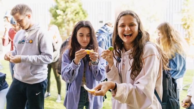 Students laugh and react to the strong taste of citrus