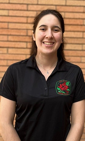 A headshot of Aubrey Goings, wearing a black Rose Float polo.