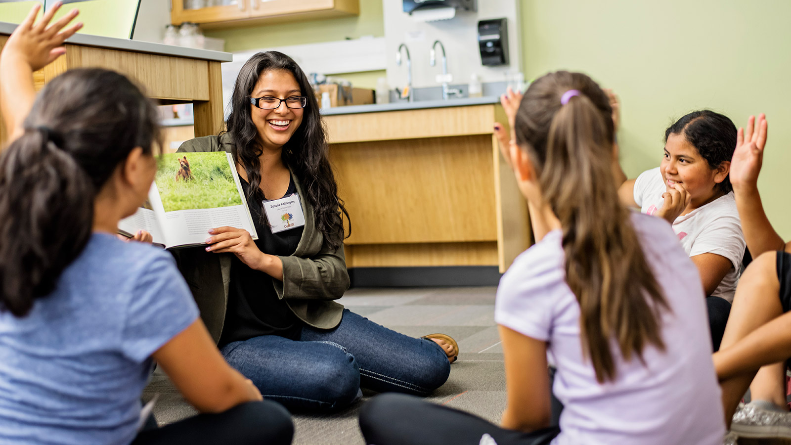 Liberal Studies student reading to a group of elementary students
