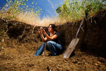 Nabila Wildman analyzes soil in the field.