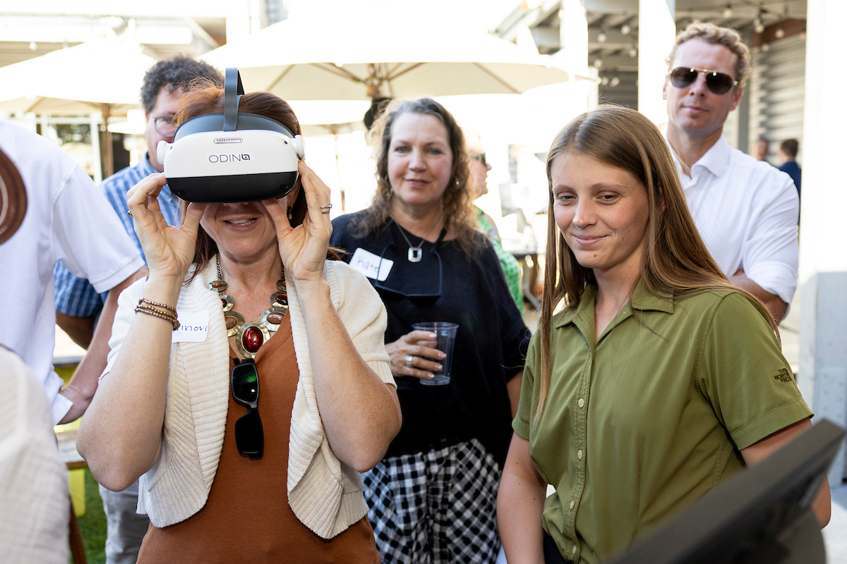 A woman tries on a VR headset during Demo Day.