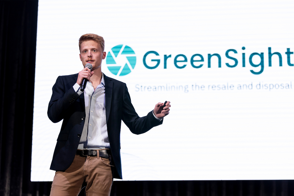 GreenSight Tech's CEO Jake Daniels presents on a stage.