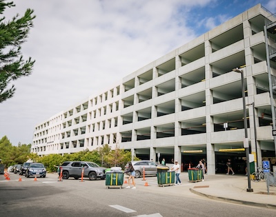 Parking structure with new students rolling in moving bins.