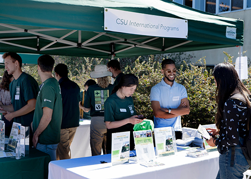 A student speaks to Study Abroad reps at a past Study Abroad Fair