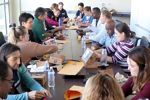 People line both sides of a long table