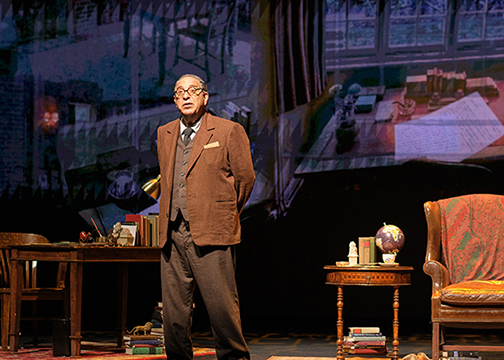  An actor portraying CS Lewis on stage on a set resembling an office