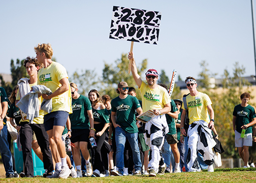 Student orientation leaders from group 282 wear cow costumes as they walk with their group on the first day of WOW