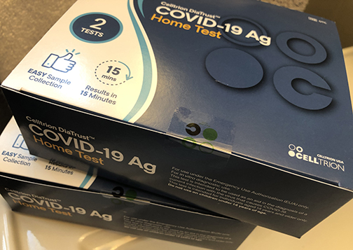 Two boxes each containing two COVID 19 test kits