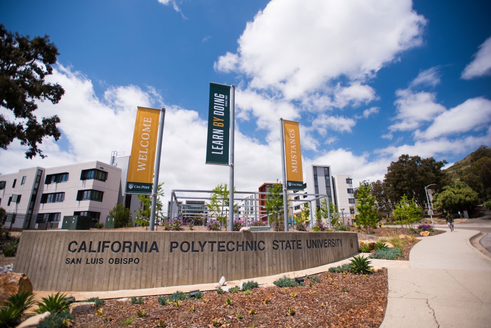 Cal Poly Grand Ave entrance with flag that reads Learn by Doing.