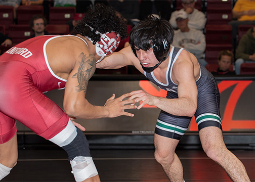 Cal Poly wrestler Dom Mendez competes against an opponent from Stanford