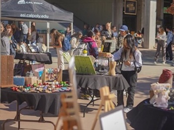 Tables with vendors and crafts are displayed for shoppers.