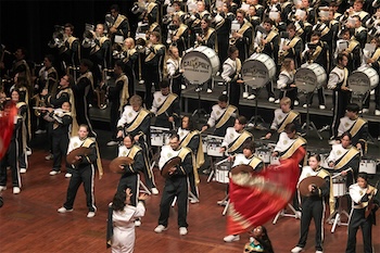 Cal Poly marching band performs on stage.