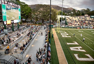 North end of the Cal Poly football field, featuring Cal Poly Partners Plaza Terrace and excited fans.