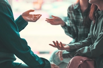 Abstract photo of people talking to illustrate Difficult Dialogue Facilitator Training.