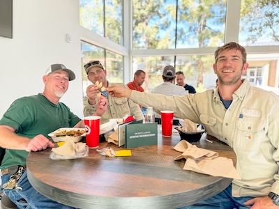 Three people dining at a table.