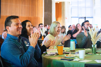 Attendees at the 2024 HSI Symposium clapping and cheering for the Cal Poly 25% Latine enrollment announcement.