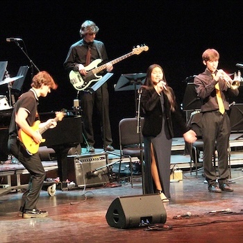 Musicians play on stage.