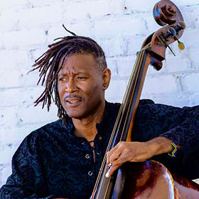 Portrait of Marcus Shelby playing a stand-up bass