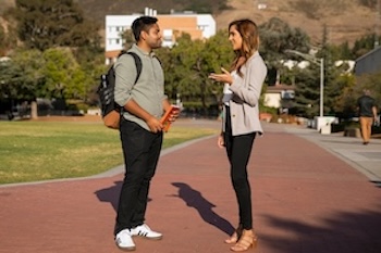   Student and mentor chat on campus.  