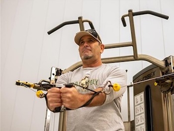 Man working out on gym equipment. 