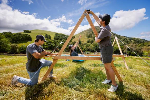 Architecture students assemble a structure in Poly Canyon during Design Village in the spring of 2024.