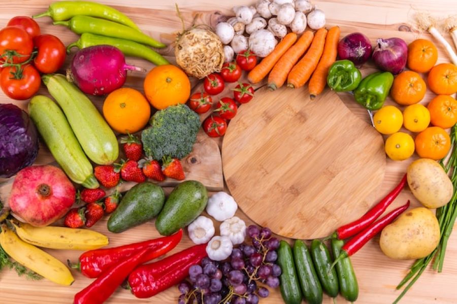 Colorful fruits and vegetables on a wood countertop. 