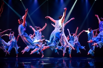 Dancers on stage perform. 