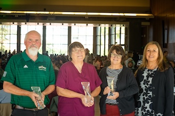 Student Affairs employees receive Chandler awards. Recipients hold their awards.