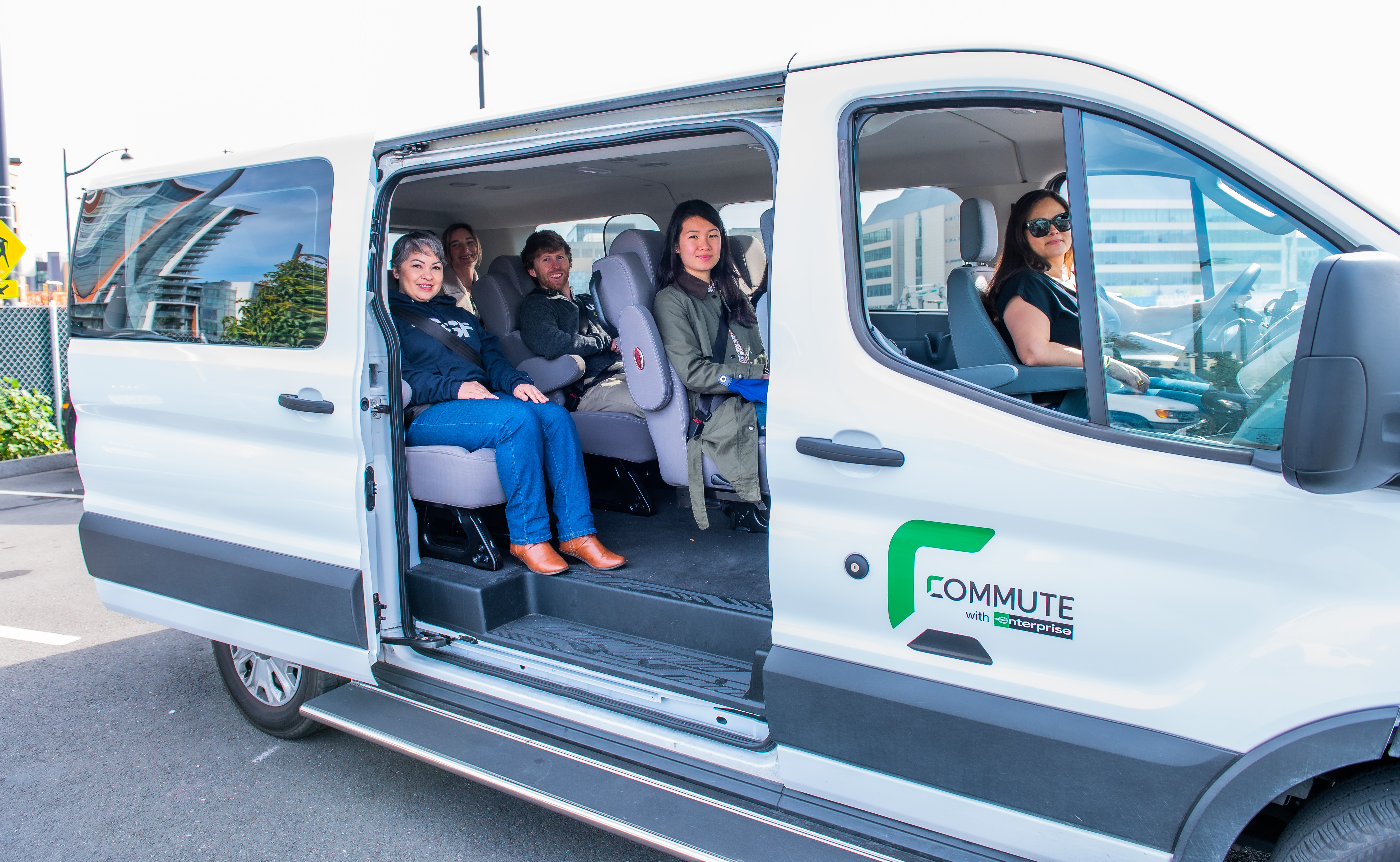 Carpool commuters in van with sliding door open.