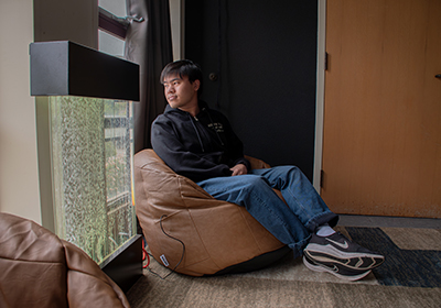 A student sits in a beanbag chair during the soft opening of the DRC Serenity Room.