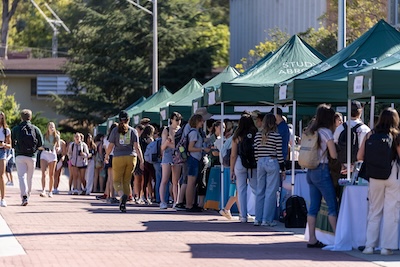 Photo of students visiting booths at the 2023 Study Abroad Fair.