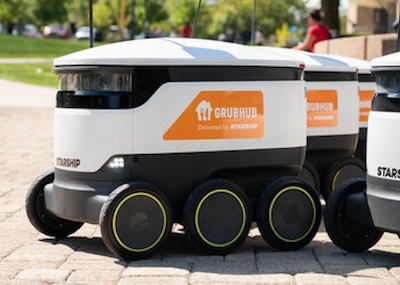 Robot with three sets of wheels and Grubhub sticker on side.