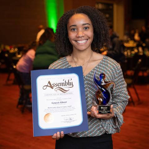 Genenis Glover smiles broadly holding her MLK Awards