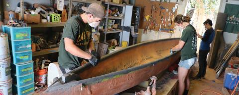 students working on a concrete canoe