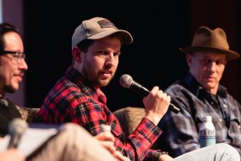 Jon Heder holds a microphone onstage at the Cal Poly PAC.