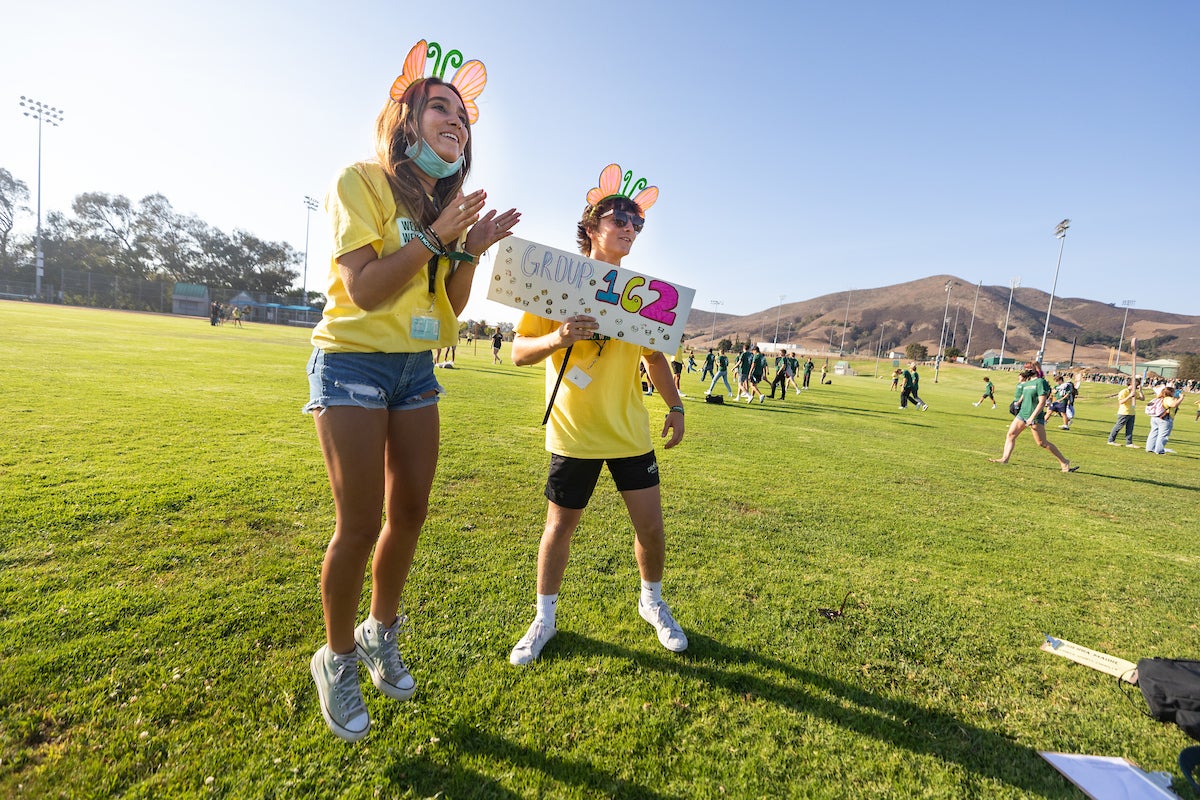 Two week of welcome leaders wear yellow shirts and jump up and down as they wait for WOWies.