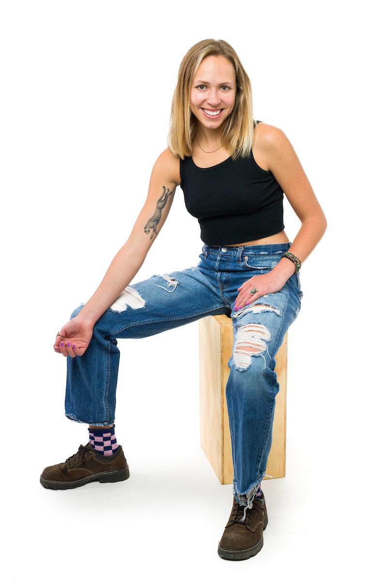 A young woman shows off a tattoo of a running cheetah on her arm