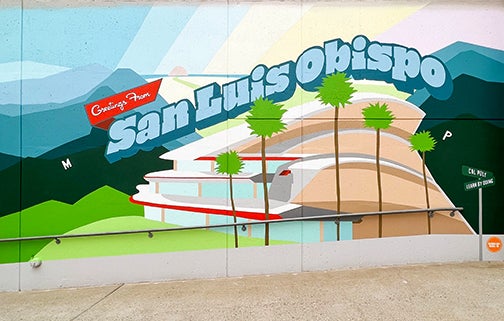 the colorful mural shows the PAC buildiing and palm trees