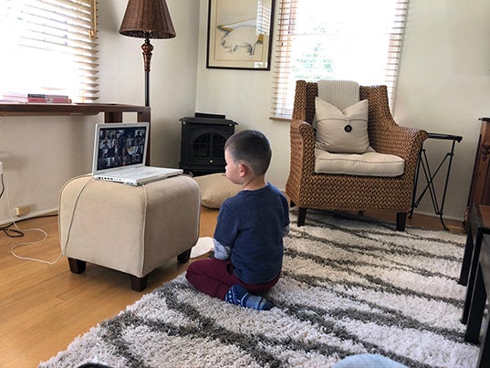 Preschool student Edro sits in front of a laptop during one of the Preschool Learning Lab's virtual sessions. 