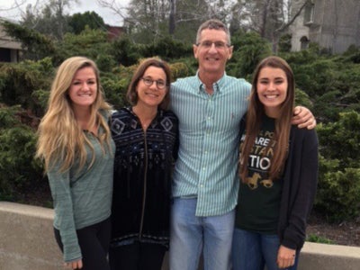 A father, mother and daughter pose with a new Cal Poly student in the local connections program