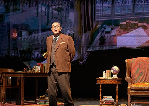  An actor portraying CS Lewis on stage on a set resembling an office