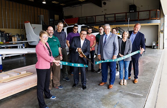 Congressman Salud Carbajal (D-Santa Barbara) celebrates with Cal Poly leaders the cutting-edge aviation research aerospace faculty and students are conducting during a tour and ribbon cutting  on April 11.