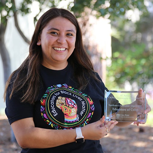 Cecilia Guzman receiving an award for the Educators of Color organization.