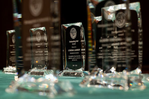 Outstanding staff awards sit on a table at Fall Convocation