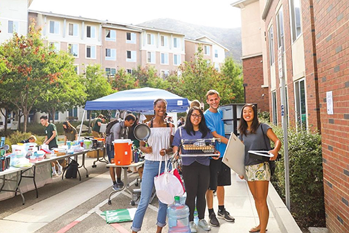 Students pose with items they purchased at a past CP Thrift shop event.