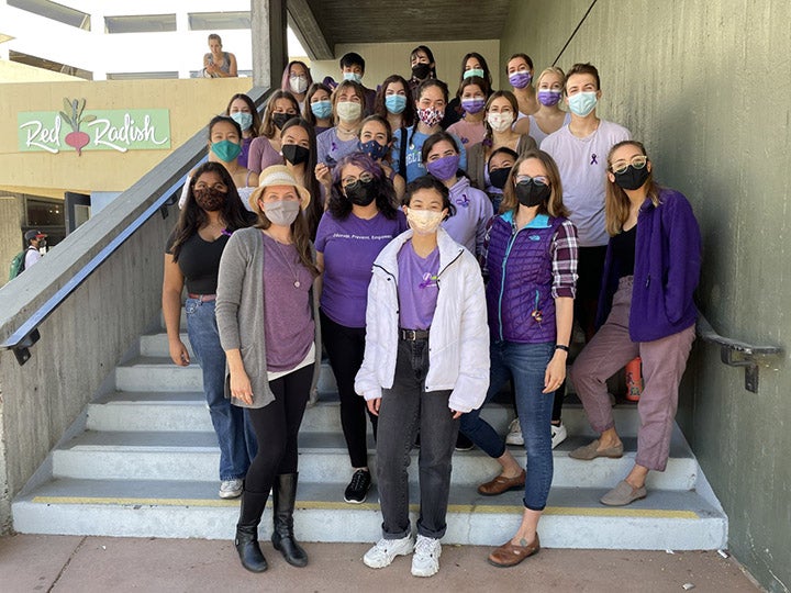 The Purple Thursday group gathered on the steps outside Red Radish in the University Union Plaza in 2021.