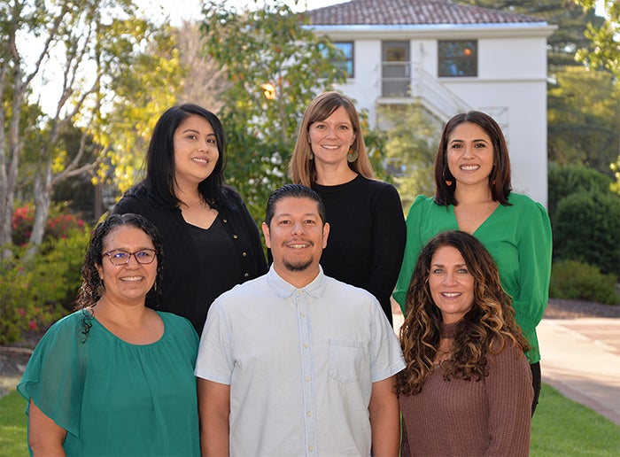 A group of six Cal Poly staff members of different genders. 