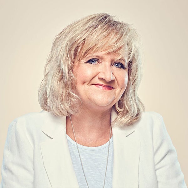 Chonda Pierce smiling in cream blazer and white t-shirt